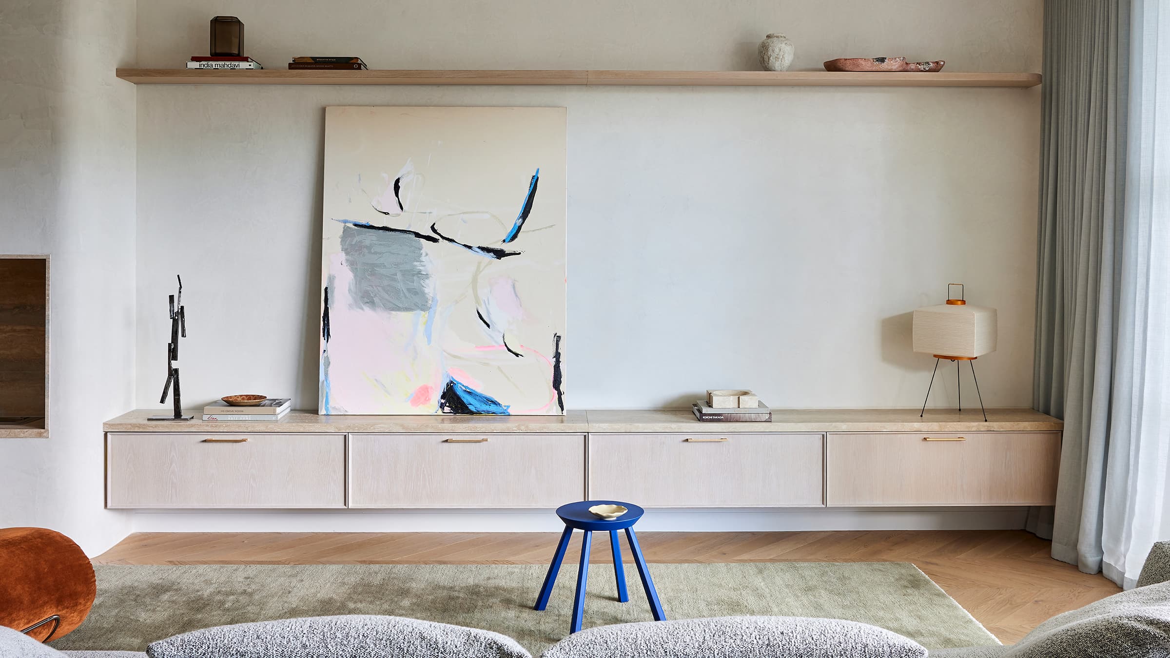 View of a wall with painting and furnished cabinets