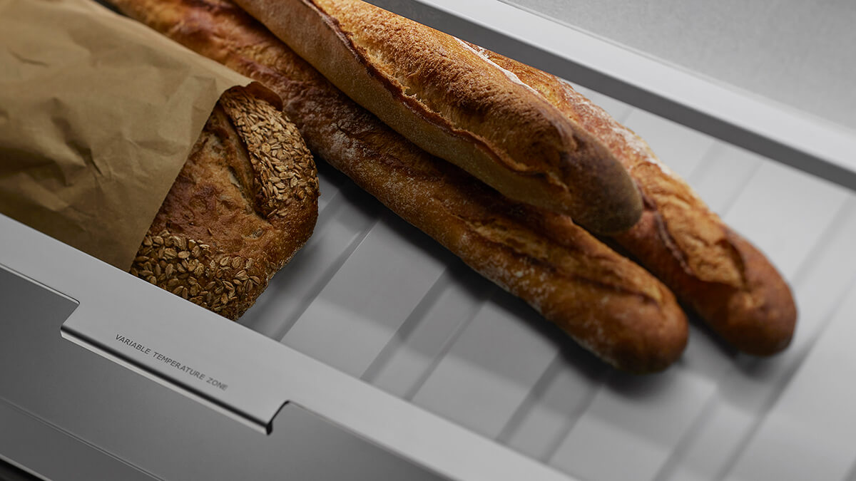 Well-organized refrigerator pantry drawer showing meat and seafood storage