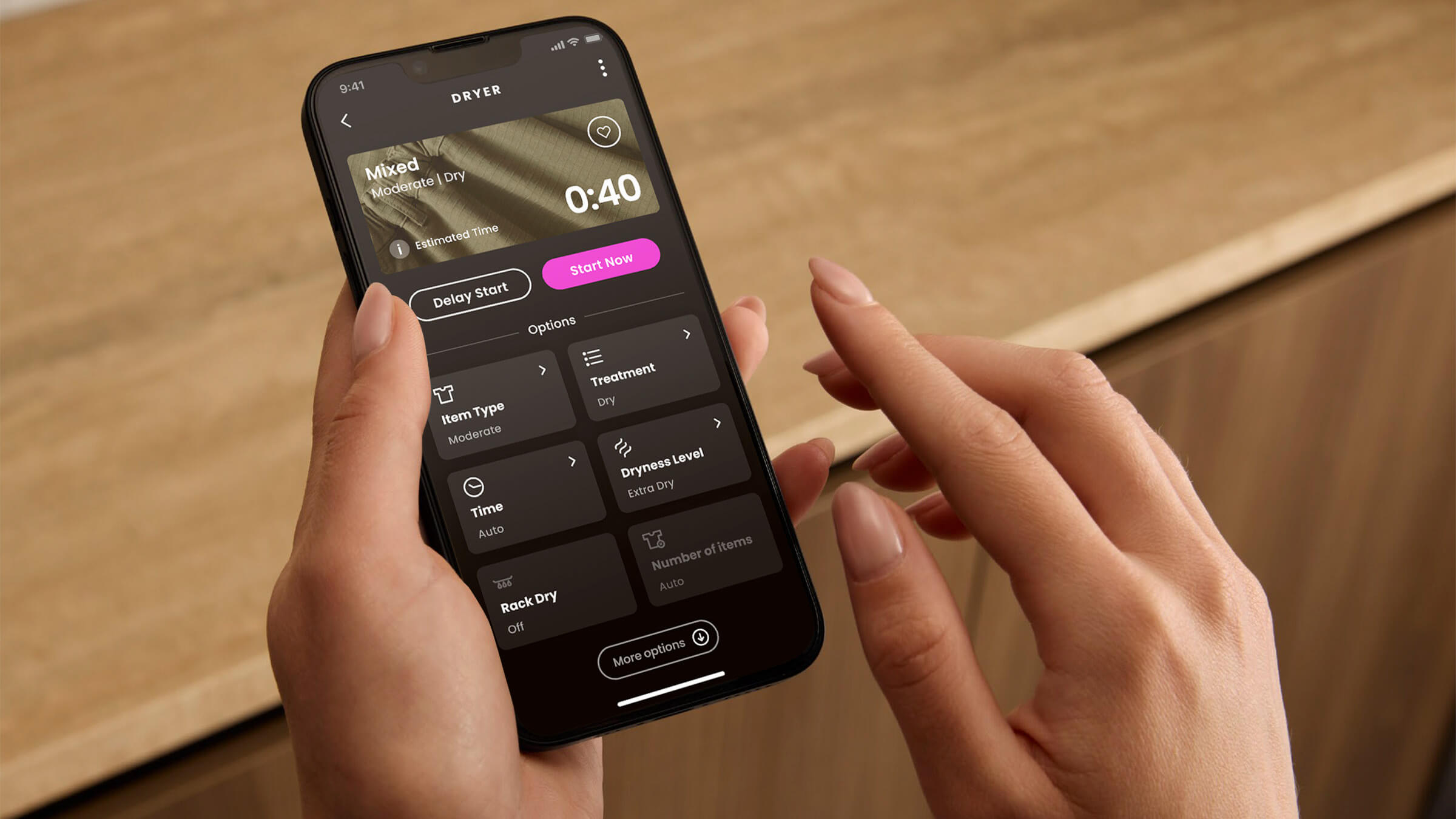 Hand selecting a cycle on the touch control of a Fisher & Paykel laundry appliance