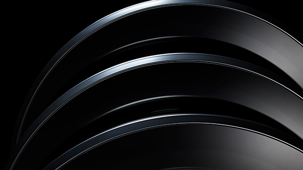 Close-up of stacked washer dryer door rings on black background